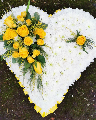 Heart SYM-324 - A white massed heart with yellow and purple spray, designed with love by our floristry team using the freshest flowers available.
